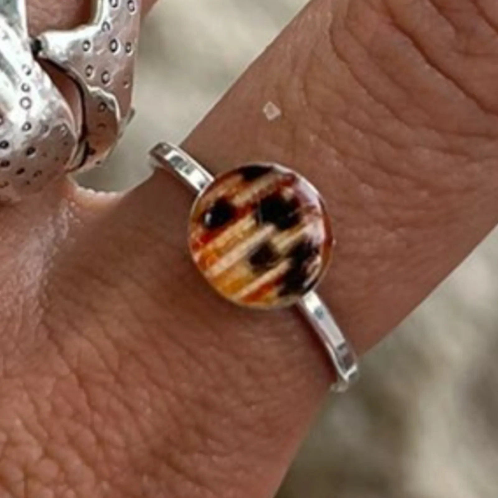 A lionfish fin ring on a hand