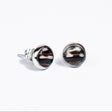 Pair of stainless steel silver setting and black and white lionfish fin stud earrings on a white background.