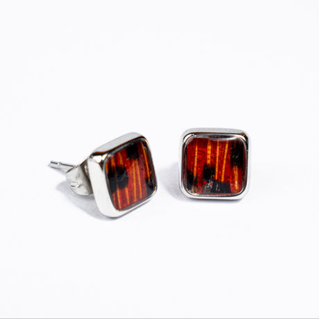 Square stud stainless steel earrings with red-colored lionfish fin on a white background